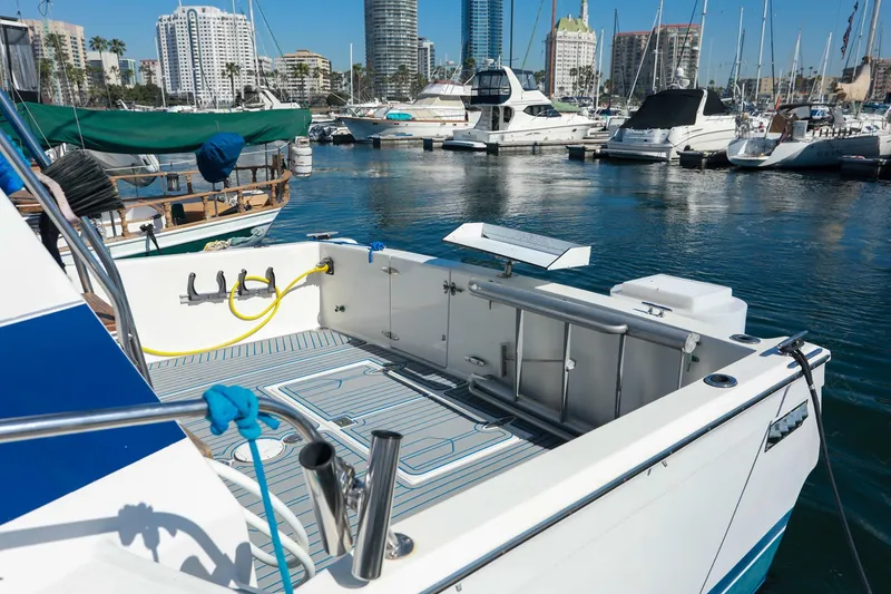 Slide: The Image of 1988 Mediterranean 38 Convertible yacht docked in a marina with city skyline. - 21