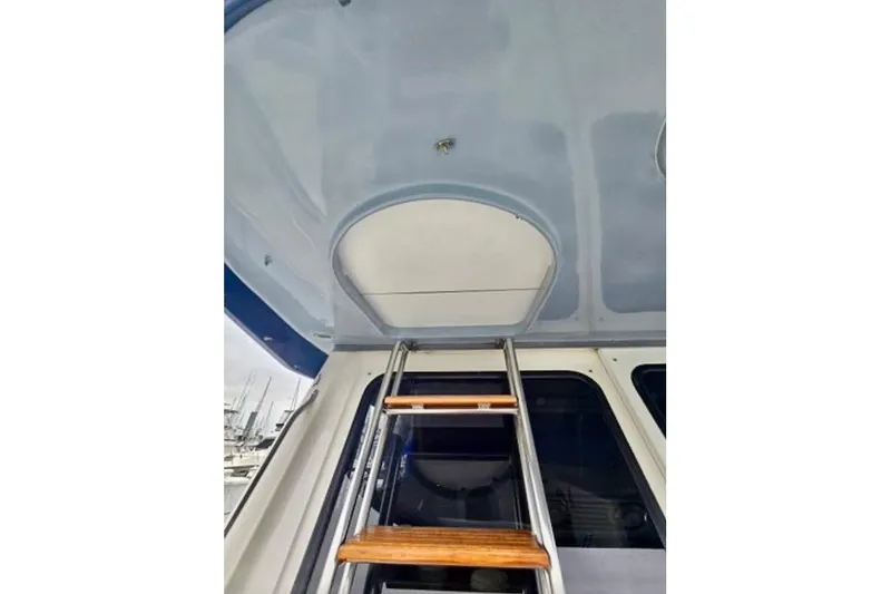 Slide: The Image of Ladder leading to upper deck on 1988 Mediterranean 38 Convertible boat. - 22