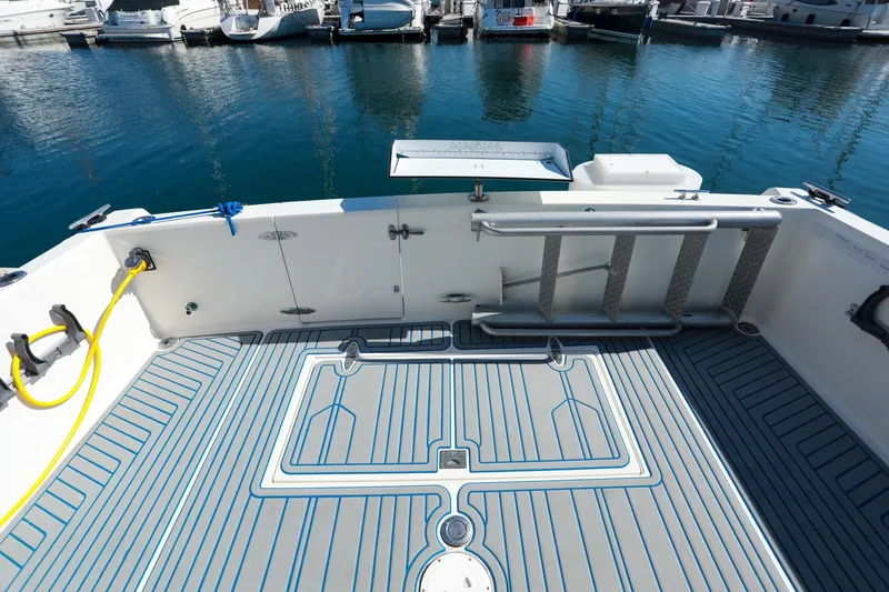 Slide: The Image of 1988 Mediterranean 38 Convertible boat deck with ladder and water hose at marina. - 24