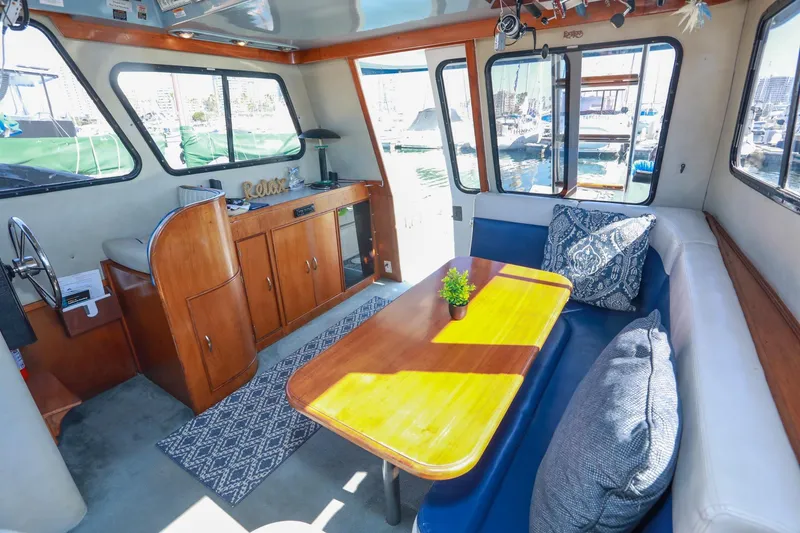 Slide: The Image of Interior of 1988 Mediterranean 38 Convertible yacht with cozy seating and wooden accents. - 26