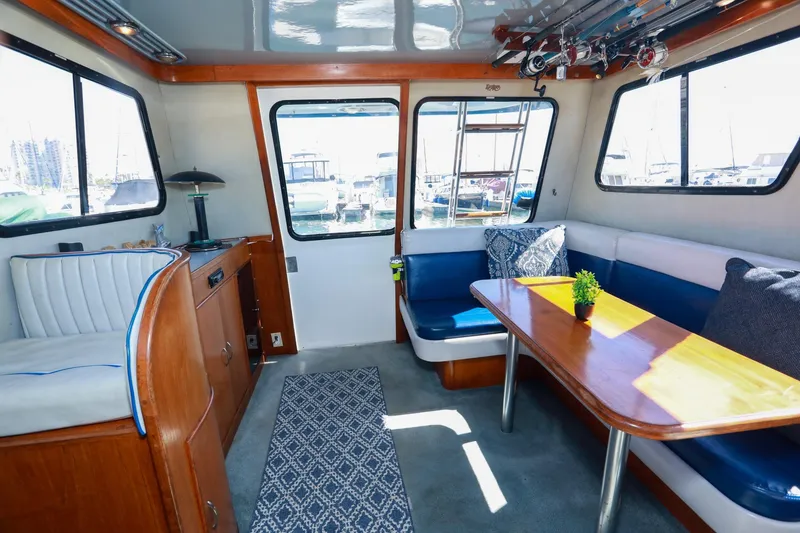 Slide: The Image of Interior of a 1988 Mediterranean 38 Convertible yacht with seating and table. - 27