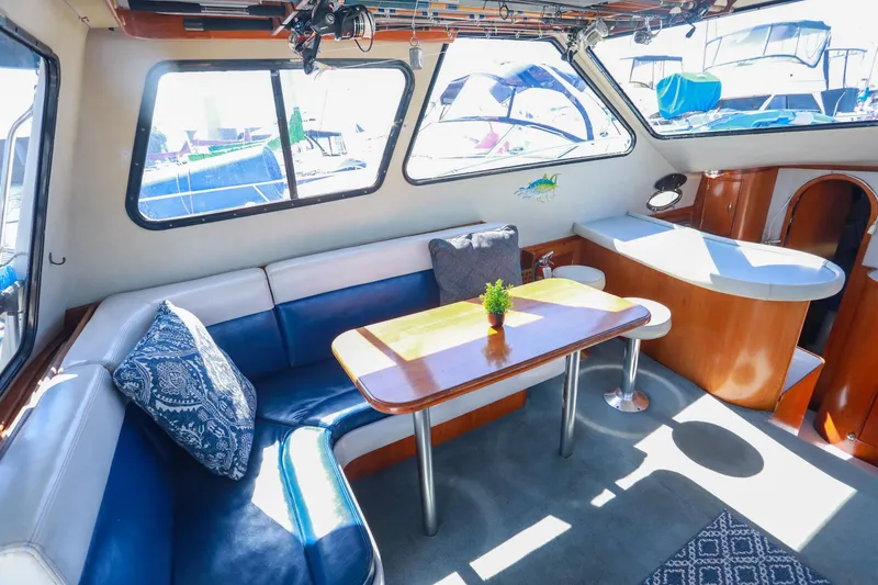 Slide: The Image of Interior of 1988 Mediterranean 38 Convertible yacht with cozy seating and dining area. - 28