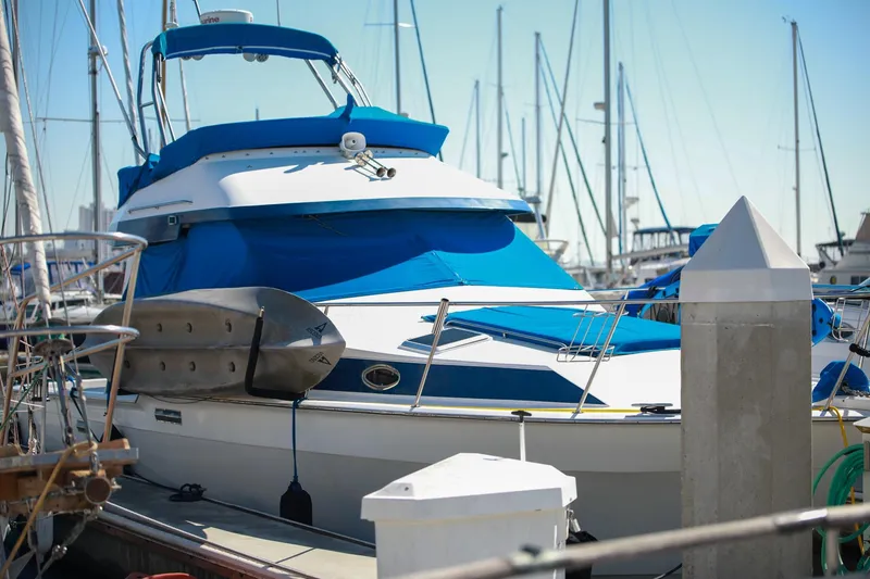 Slide: The Image of 1988 Mediterranean 38 Convertible yacht docked at marina with blue covers. - 3