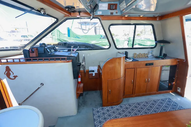 Slide: The Image of Interior of a 1988 Mediterranean 38 Convertible yacht with wooden cabinetry and nautical decor. - 30