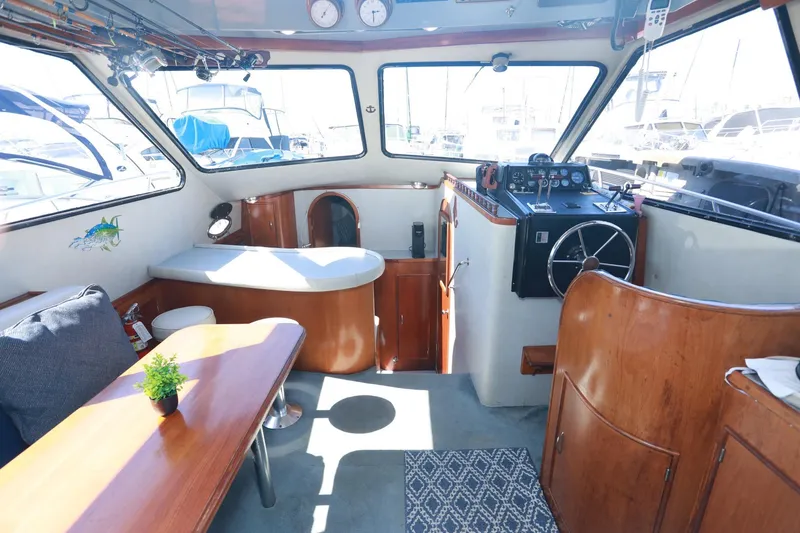 Slide: The Image of Interior of a 1988 Mediterranean 38 Convertible yacht with wooden furnishings and helm. - 31