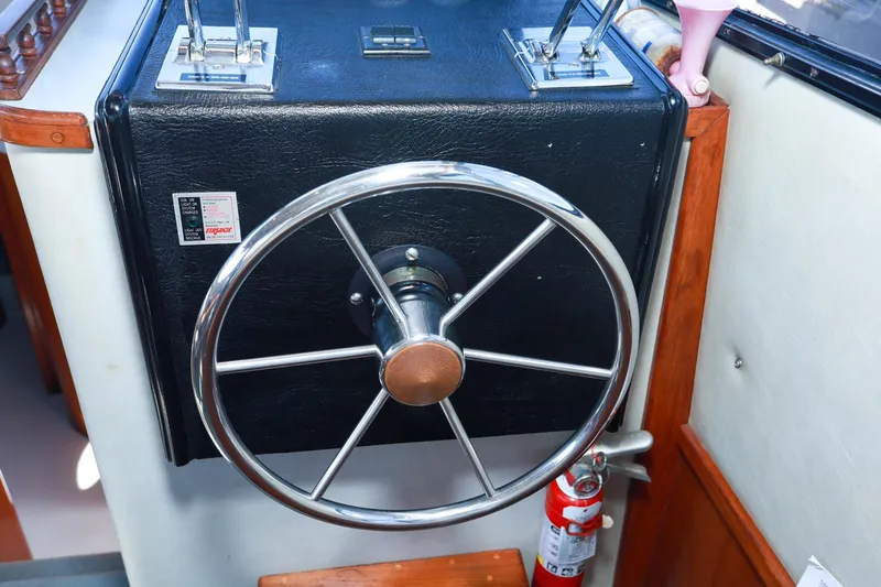 Slide: The Image of Steering wheel of a 1988 Mediterranean 38 Convertible boat, featuring a classic design. - 32