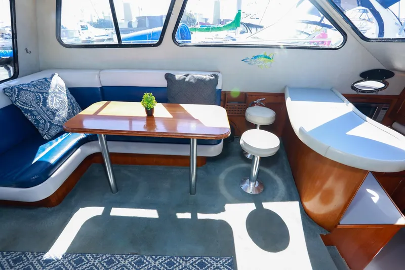 Slide: The Image of Interior of a 1988 Mediterranean 38 Convertible yacht with seating and table. - 35