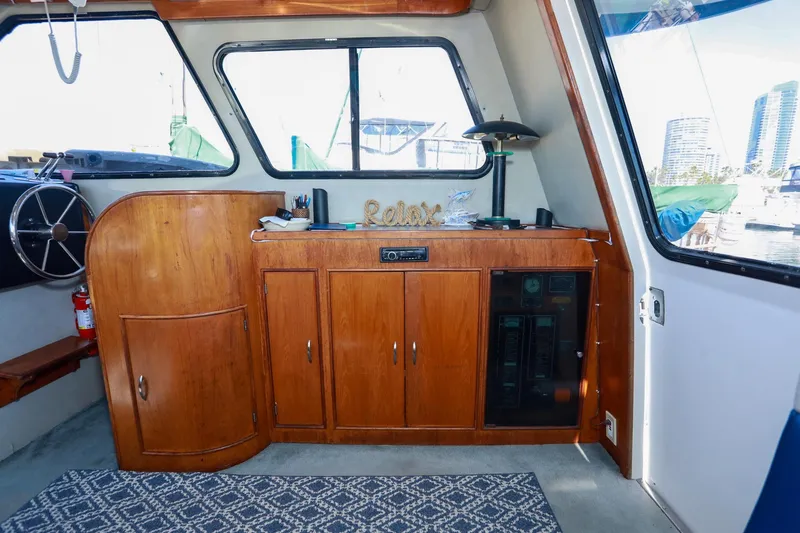 Slide: The Image of Interior of a 1988 Mediterranean 38 Convertible boat with wooden cabinetry and nautical decor. - 36