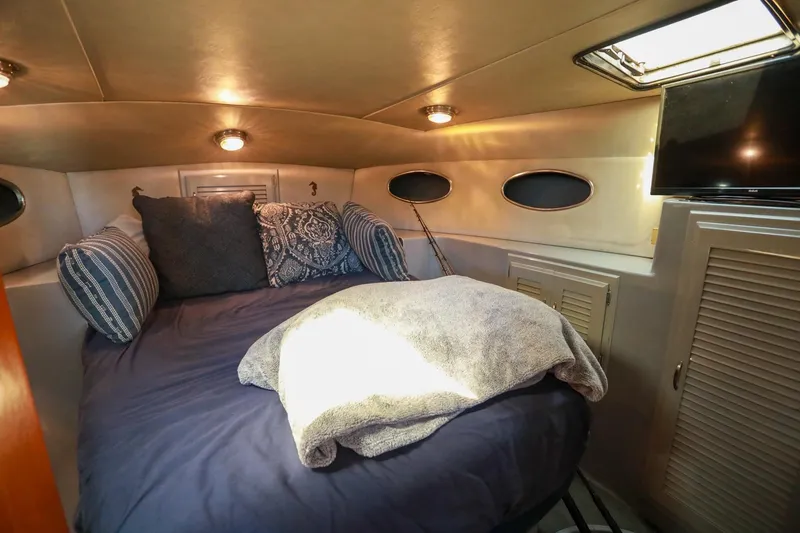 Slide: The Image of Cozy cabin interior of 1988 Mediterranean 38 Convertible yacht with bed and TV. - 43