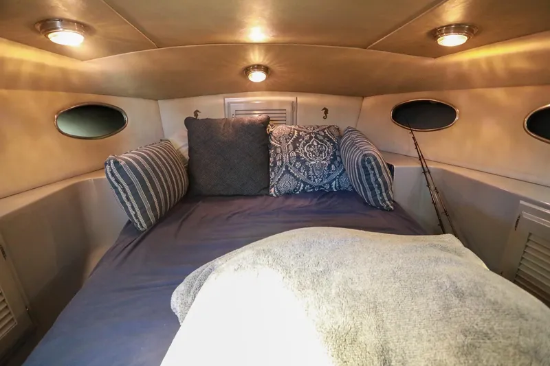 Slide: The Image of Cozy cabin interior of 1988 Mediterranean 38 Convertible with plush pillows and ambient lighting. - 44