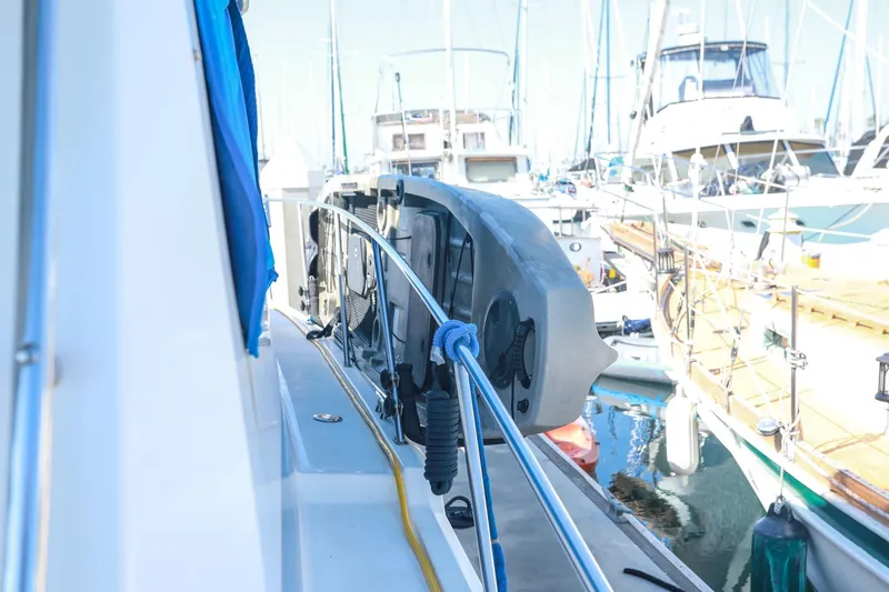 Slide: The Image of 1988 Mediterranean 38 Convertible yacht docked at marina with visible railing and equipment. - 5