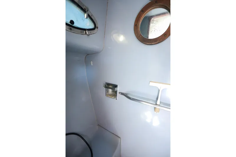 Slide: The Image of Interior of 1988 Mediterranean 38 Convertible boat with porthole and shelf. - 50