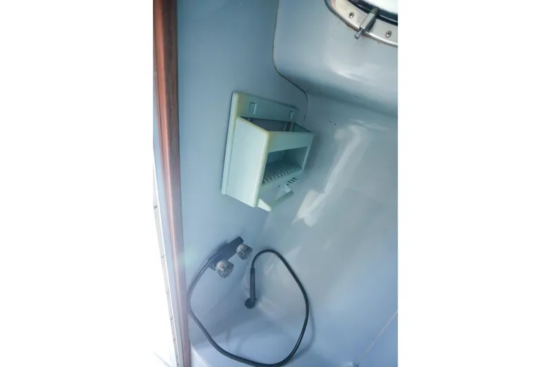 Slide: The Image of 1988 Mediterranean 38 Convertible boat interior with wall-mounted fixture and cable. - 51