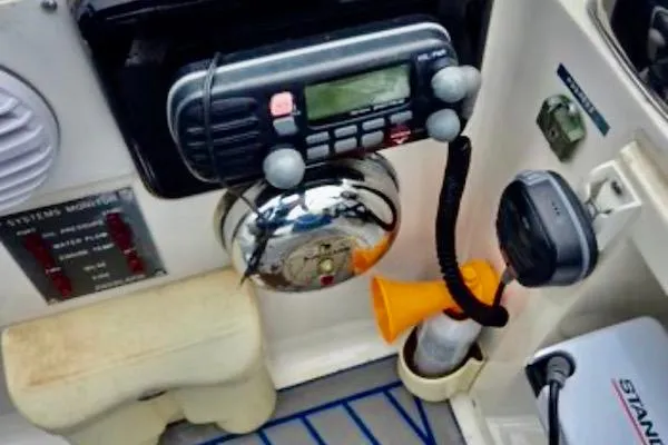 Slide: The Image of Control panel of a 1988 Mediterranean 38 Convertible boat with radio and safety equipment. - 52