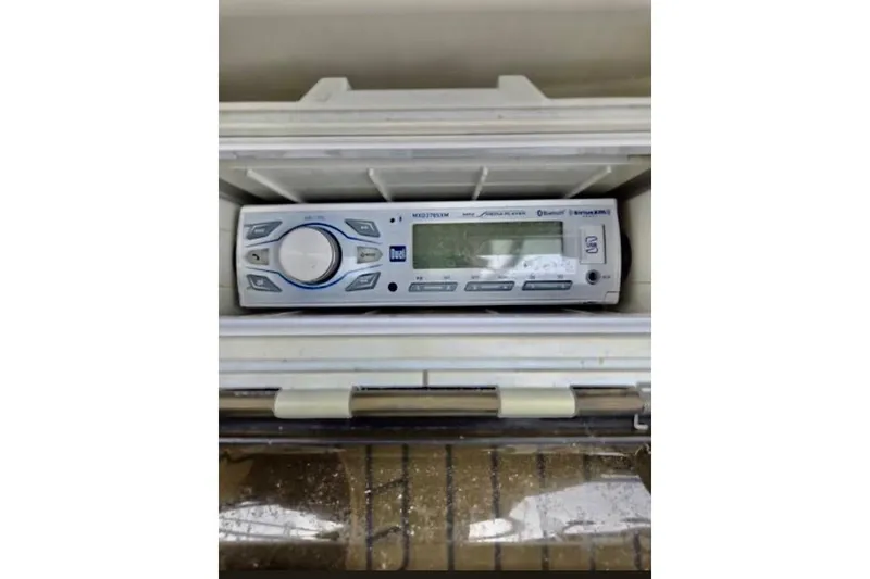 Slide: The Image of Radio unit inside a 1988 Mediterranean 38 Convertible boat, featuring modern controls. - 54