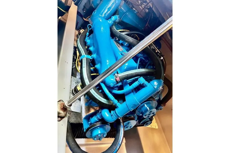 Slide: The Image of Engine of 1988 Mediterranean 38 Convertible, painted blue, with visible hoses and components. - 56