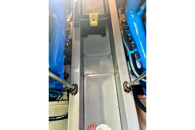 Slide: The Image of Engine room of a 1988 Mediterranean 38 Convertible boat with blue machinery. - 61