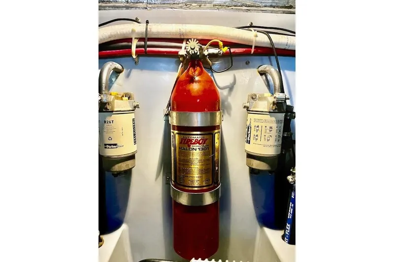 Slide: The Image of Engine room of 1988 Mediterranean 38 Convertible with fire extinguisher and filters. - 62