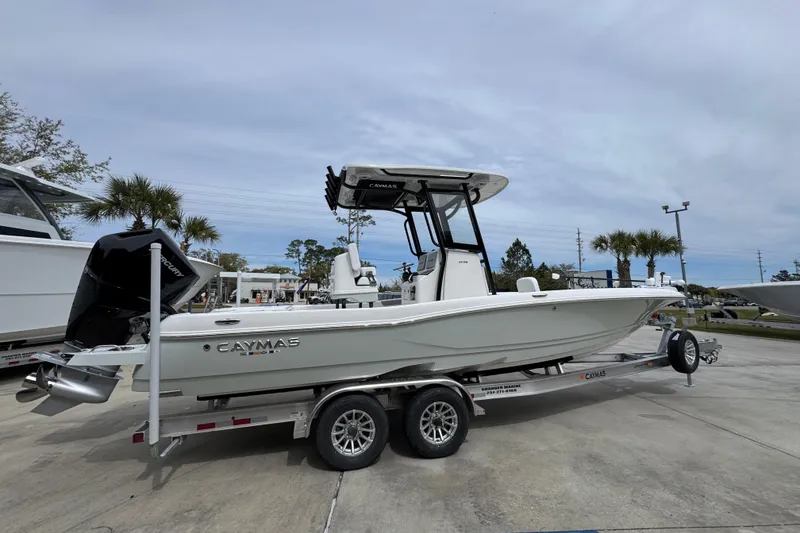 Slide: The Image of 2026 Caymas 26 HB boat on trailer, displayed outdoors under cloudy sky. - 10