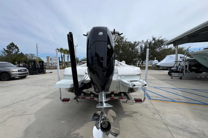 Slide: The Image of 2026 Caymas 26 HB boat with powerful outboard motor on trailer in marina. - 13