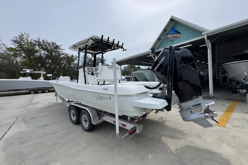 Slide: The Image of 2026 Caymas 26 HB boat on trailer with Mercury outboard motor at marina. - 15