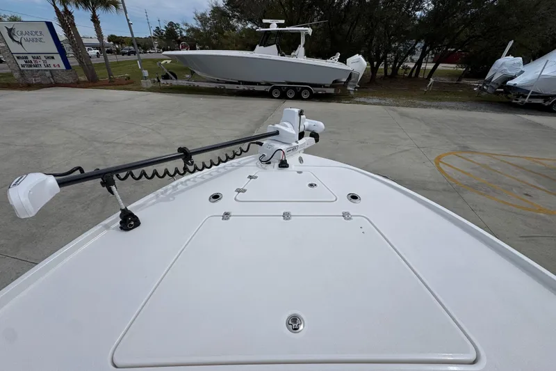 Slide: The Image of 2026 Caymas 26 HB boat deck with trolling motor, parked at Grander Marine. - 20