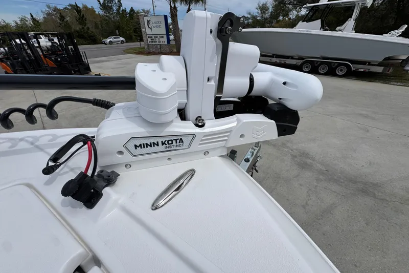 Slide: The Image of Minn Kota Instinct motor on 2026 Caymas 26 HB boat, parked outdoors. - 21