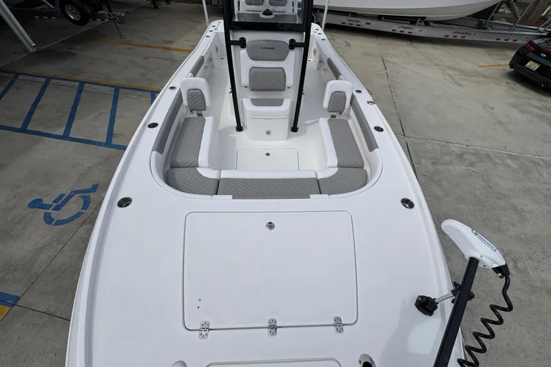 Slide: The Image of 2026 Caymas 26 HB boat interior with seating and storage, parked in a lot. - 22