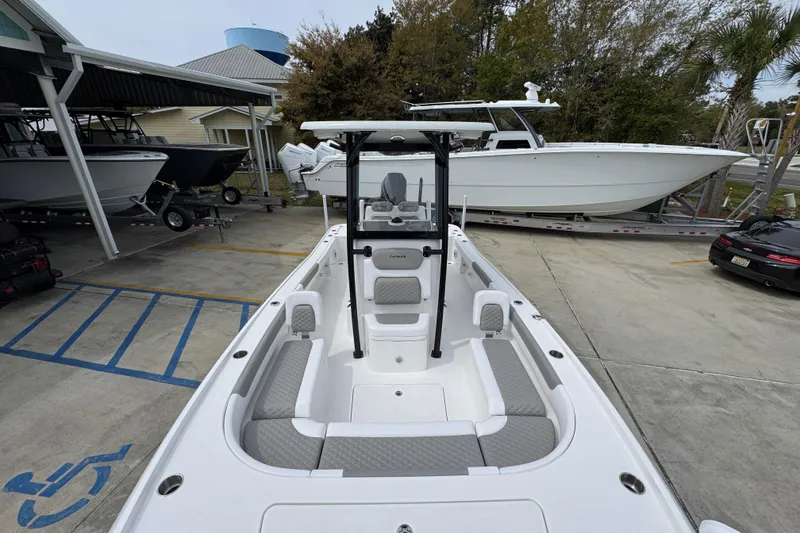 Slide: The Image of 2026 Caymas 26 HB boat in a marina, showcasing spacious seating and sleek design. - 23