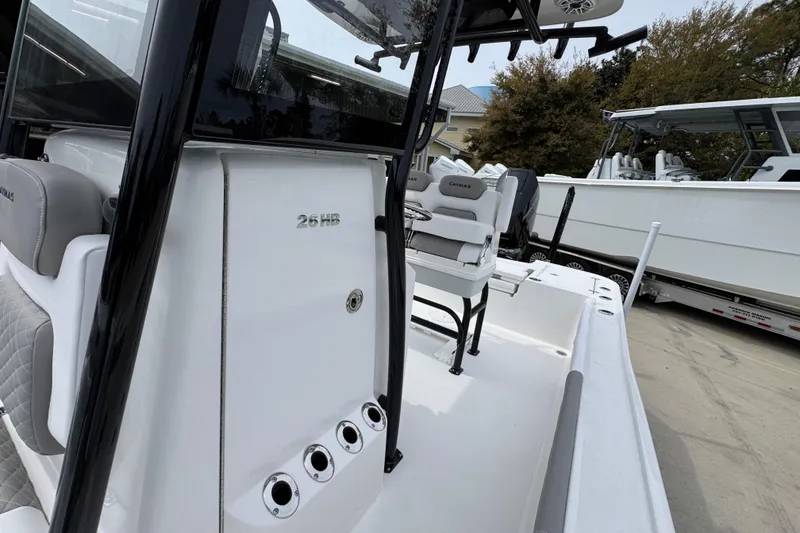 Slide: The Image of 2026 Caymas 26 HB boat interior with seating and console details. - 25