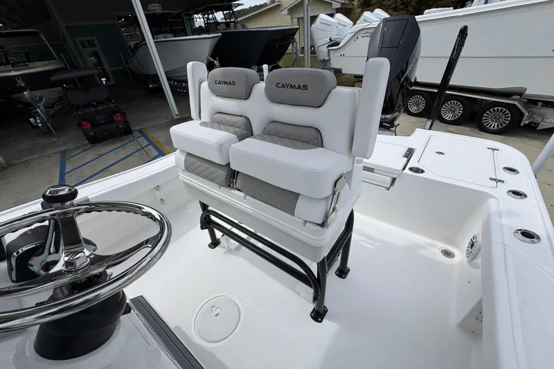 Slide: The Image of 2026 Caymas 26 HB boat interior with dual seats and steering wheel. - 28