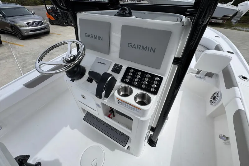 Slide: The Image of 2026 Caymas 26 HB boat console with Garmin displays and Mercury controls. - 35