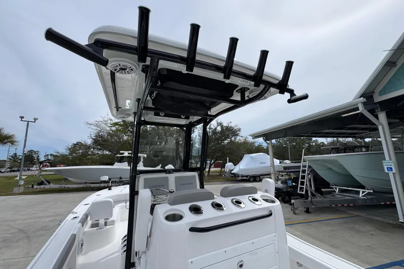 Slide: The Image of 2026 Caymas 26 HB boat with T-top and Garmin electronics in a marina setting. - 37