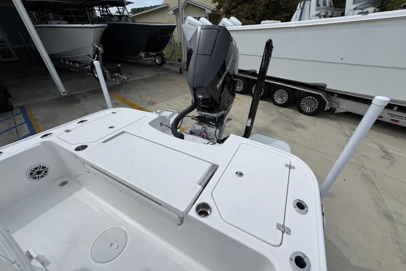 Slide: The Image of 2026 Caymas 26 HB boat with Mercury outboard motor, docked at a marina. - 38