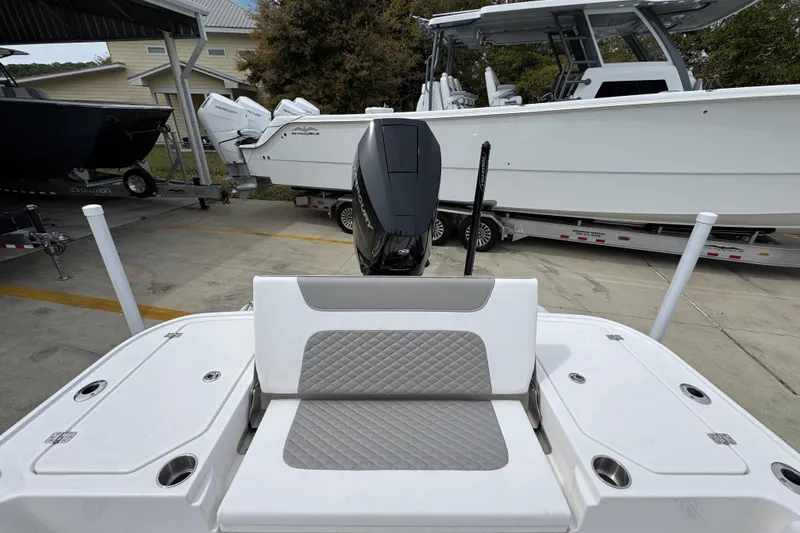 Slide: The Image of 2026 Caymas 26 HB boat with outboard motor, parked on a trailer. - 39