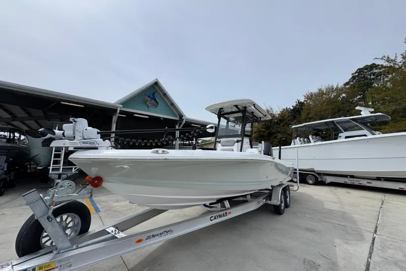 Slide: The Image of 2026 Caymas 26 HB boat on trailer at marina, ready for launch. - 4