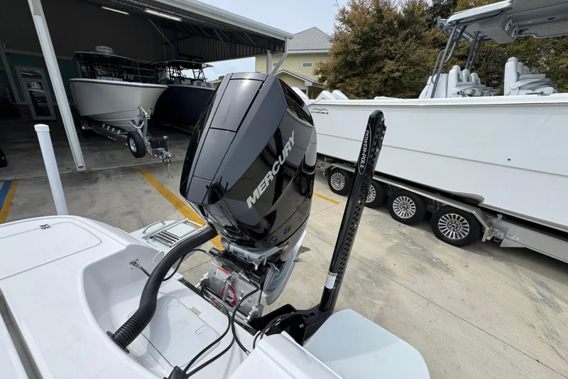 Slide: The Image of 2026 Caymas 26 HB boat with Mercury engine in a marina setting. - 40