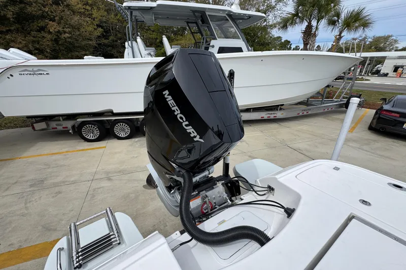 Slide: The Image of 2026 Caymas 26 HB boat with Mercury engine, parked on a trailer. - 41