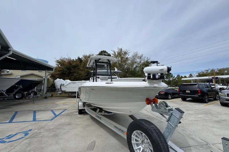 Slide: The Image of 2026 Caymas 26 HB boat on trailer in parking lot, ready for transport. - 7