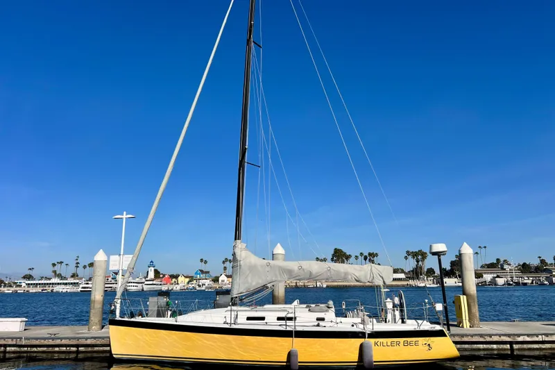 The Image of Yellow 2003 J/109 sailboat docked at marina. - 0
