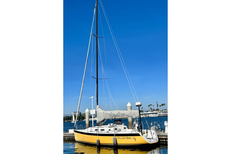 Slide: The Image of Yellow 2003 J Boats J/109 sailboat docked under clear blue sky. - 10