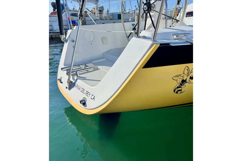 Slide: The Image of 2003 J Boats J/109 sailboat stern in Marina del Rey, CA, with cartoon bee graphic. - 16