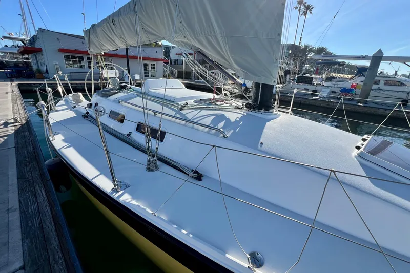 Slide: The Image of 2003 J Boats J/109 sailboat docked at marina, showcasing sleek design and rigging. - 23