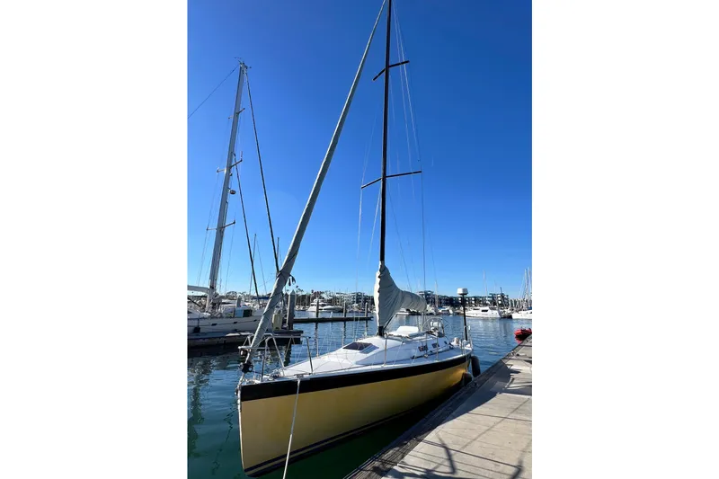 Slide: The Image of 2003 J Boats J/109 sailboat docked at marina under clear blue sky. - 24