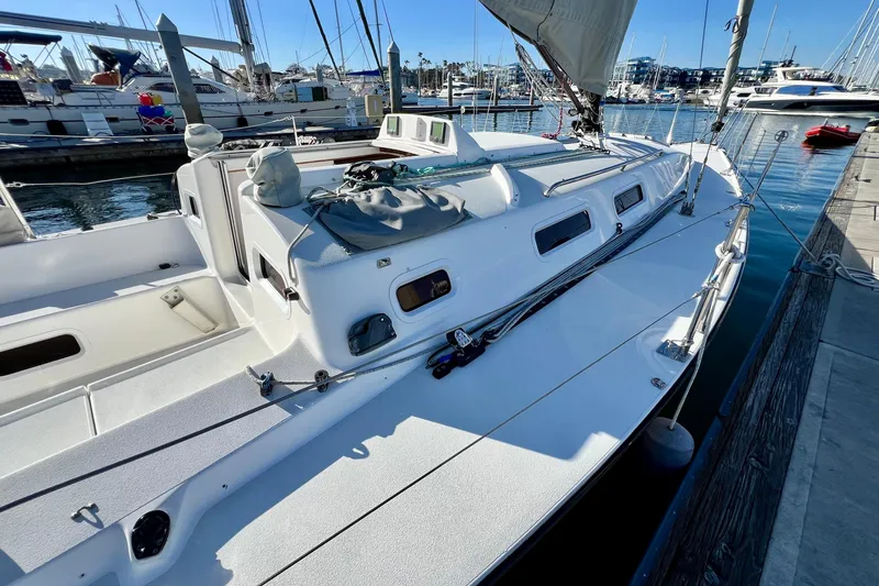 Slide: The Image of 2003 J Boats J/109 sailboat docked in a marina, showcasing sleek design and deck features. - 25