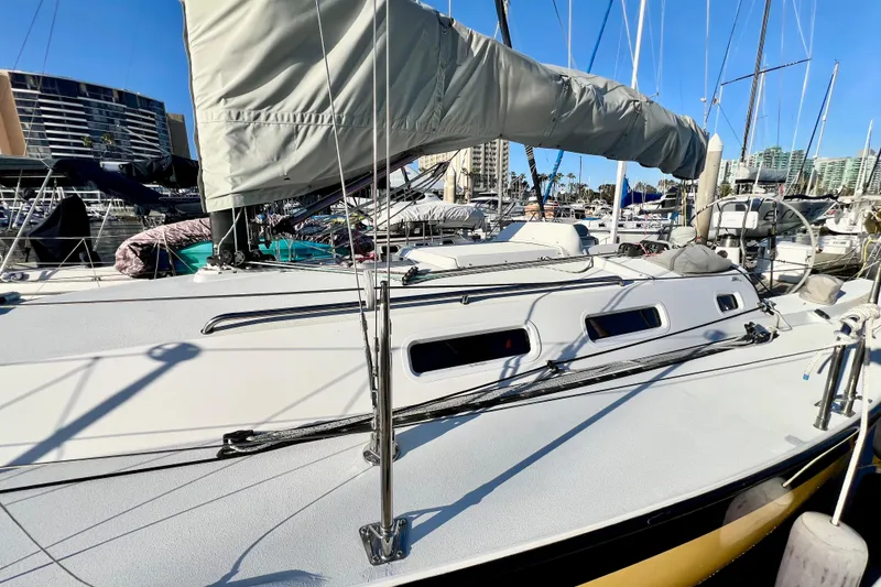 Slide: The Image of 2003 J Boats J/109 sailboat docked in marina, featuring sleek design and covered sails. - 29