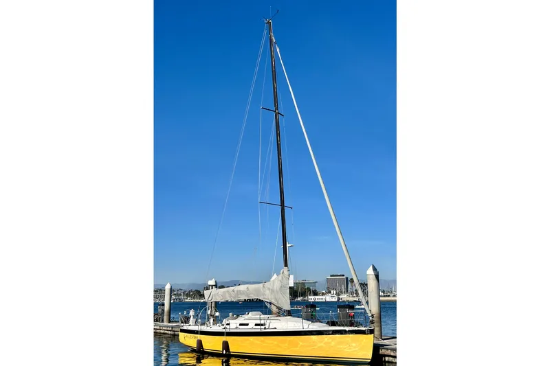 Slide: The Image of Yellow 2003 J Boats J/109 sailboat docked under clear blue sky. - 3