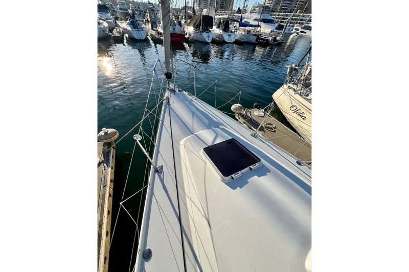 Slide: The Image of 2003 J Boats J/109 sailboat docked in a marina, surrounded by other vessels. - 33