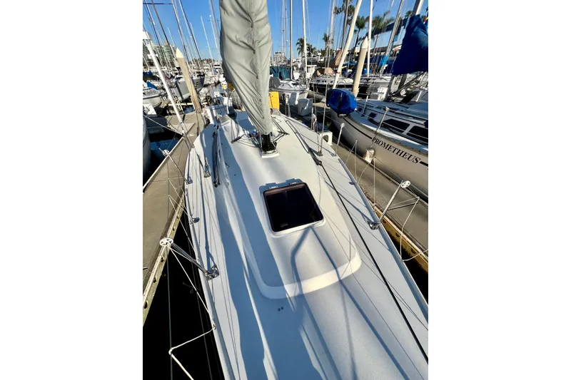 Slide: The Image of 2003 J Boats J/109 sailboat deck view in marina, showcasing sleek design and rigging. - 37