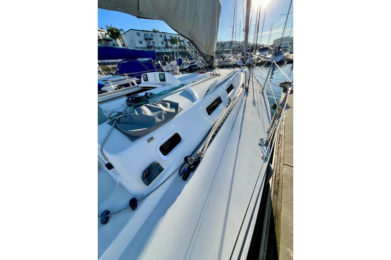 Slide: The Image of 2003 J Boats J/109 sailboat docked in marina, showcasing sleek deck design. - 39